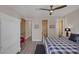 This bedroom features a ceiling fan, wood-look floors, and natural wood doors at 3173 Lido Isle Ct, Las Vegas, NV 89117