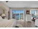 Bright bedroom featuring a white bed frame, wood floors, balcony access and office area at 3173 Lido Isle Ct, Las Vegas, NV 89117