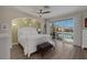 Bright bedroom featuring a white bed frame, wood floors, balcony access and ceiling fan at 3173 Lido Isle Ct, Las Vegas, NV 89117