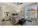 Comfortable bedroom featuring a white bed frame, wood floors, balcony access and ceiling fan at 3173 Lido Isle Ct, Las Vegas, NV 89117