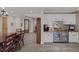 Open dining room with a bar area, complete with white cabinetry, wine fridge, and adjacent to the living area at 3173 Lido Isle Ct, Las Vegas, NV 89117