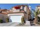 Two-story home with a white garage door and red umbrella at 3173 Lido Isle Ct, Las Vegas, NV 89117