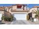 Two-story home with a white garage door and red umbrella at 3173 Lido Isle Ct, Las Vegas, NV 89117