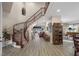 Elegant foyer featuring a curved staircase, wood floors, and views into multiple living spaces at 3173 Lido Isle Ct, Las Vegas, NV 89117