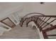 Top-down view of the foyer showcases the curved staircase, wood flooring, and elegant entry at 3173 Lido Isle Ct, Las Vegas, NV 89117