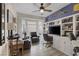 Well-lit home office featuring built-in shelving, comfortable seating, and a bay window at 3173 Lido Isle Ct, Las Vegas, NV 89117