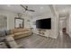 Cozy living area features a large sectional sofa, a big screen television, and wood-style flooring at 3173 Lido Isle Ct, Las Vegas, NV 89117