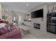 Living room with fireplace, wet bar, and leather furniture at 3173 Lido Isle Ct, Las Vegas, NV 89117