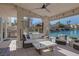 Outdoor patio area with lake view, grill, ceiling fan, and plush outdoor seating at 3173 Lido Isle Ct, Las Vegas, NV 89117