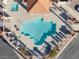 Aerial view of a community pool surrounded by well-maintained landscaping and a covered area at 3173 Lido Isle Ct, Las Vegas, NV 89117