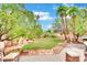 Landscaped backyard featuring a lush lawn and stone pathway at 3380 Shallow Pond Dr, Las Vegas, NV 89117