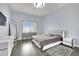 Modern bedroom with gray headboard and large window at 3380 Shallow Pond Dr, Las Vegas, NV 89117