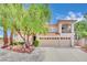 Two-story house with three-car garage and landscaped yard at 3380 Shallow Pond Dr, Las Vegas, NV 89117