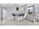 Modern wet bar with sleek countertop and three black barstools at 3380 Shallow Pond Dr, Las Vegas, NV 89117