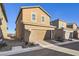 Tan two-story home with attached garage and landscaping at 3615 Bitonto Ln, Henderson, NV 89044