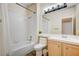 Clean bathroom with a shower/tub combo and light wood cabinets at 3790 Morning Canyon St, Las Vegas, NV 89147