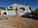 Single-story house with a two-car garage and desert landscaping at 3886 Via Lucia Dr, Las Vegas, NV 89115