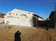 Front view of a single-story house with a two-car garage and gravel landscaping at 3886 Via Lucia Dr, Las Vegas, NV 89115