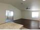 Living room with dark laminate flooring and sliding door to patio at 3886 Via Lucia Dr, Las Vegas, NV 89115