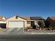 Single story home with solar panels and a two car garage at 4636 Ferrell St, North Las Vegas, NV 89031