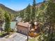 House nestled in a mountain setting with pine trees and other homes at 4765 Silver Tip Trl, Mount Charleston, NV 89124