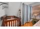 bedroom with crib, window, and gray curtains at 4765 Silver Tip Trl, Mount Charleston, NV 89124