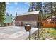 Gray metal exterior home with brown roof, paved driveway, and mailbox at 4765 Silver Tip Trl, Mount Charleston, NV 89124