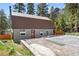 Gray metal exterior home with brown roof, paved driveway, and landscaping at 4765 Silver Tip Trl, Mount Charleston, NV 89124