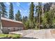 Gray metal exterior home with brown roof, and paved driveway at 4765 Silver Tip Trl, Mount Charleston, NV 89124