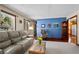 Living room with blue accent wall and hardwood floors at 4765 Silver Tip Trl, Mount Charleston, NV 89124