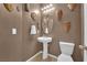 Small bathroom with pedestal sink and decorative wall art at 4823 Kinworthy St, North Las Vegas, NV 89081