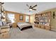 Spacious bedroom with built-in shelves and a ceiling fan at 4823 Kinworthy St, North Las Vegas, NV 89081