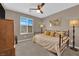 Cozy bedroom with daybed, ceiling fan, and large window at 4823 Kinworthy St, North Las Vegas, NV 89081