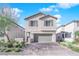 Two-story house with gray siding, a two-car garage, and a paved driveway at 4823 Kinworthy St, North Las Vegas, NV 89081