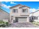 Two-story house with gray garage door and gray shutters at 4823 Kinworthy St, North Las Vegas, NV 89081