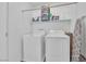 Laundry room with washer, dryer, and storage shelves at 4823 Kinworthy St, North Las Vegas, NV 89081