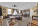 Spacious living room with leather couches, a coffee table, and a kitchen view at 4823 Kinworthy St, North Las Vegas, NV 89081