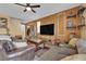 Living room with brown leather couches and an accent wall at 4823 Kinworthy St, North Las Vegas, NV 89081