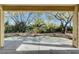 Peaceful backyard patio with mature trees and desert landscaping at 5026 Vincitor St, Las Vegas, NV 89135