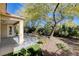 Landscaped backyard with patio and mature trees at 5026 Vincitor St, Las Vegas, NV 89135