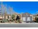 Single-story home with white garage door and landscaped front yard at 5026 Vincitor St, Las Vegas, NV 89135