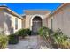 Inviting front entrance with decorative iron gate and landscaping at 5026 Vincitor St, Las Vegas, NV 89135