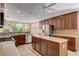 Spacious kitchen with island, stainless steel appliances, and ample cabinetry at 5026 Vincitor St, Las Vegas, NV 89135