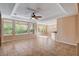 Bright and airy living room with tile floors and ceiling fan at 5026 Vincitor St, Las Vegas, NV 89135