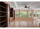 Bright living room featuring built-in shelving and tile flooring at 5026 Vincitor St, Las Vegas, NV 89135