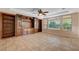 Bright living room featuring built-in shelving and tile flooring at 5026 Vincitor St, Las Vegas, NV 89135