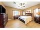 Main bedroom with king-size bed, wood floors, and large windows at 5550 Carrara Pointe St, Pahrump, NV 89061