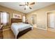 Main bedroom with king bed, en-suite bathroom access, and ceiling fan at 5550 Carrara Pointe St, Pahrump, NV 89061