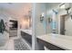 Double vanity bathroom with marble tile and walk-in closet access at 5599 Valley Mill St, Las Vegas, NV 89148