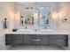 Modern bathroom with double sinks, large mirrors, and gray vanity at 5599 Valley Mill St, Las Vegas, NV 89148